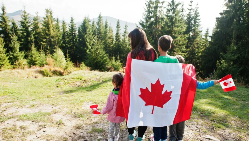 happy-canada-day-family-mother-with-three-kids-hold-large-canadian-flag-celebration-mountains happy-canada-day-family-mother-with-three-kids-hold-large-canadian-flag-celebration-mountains
